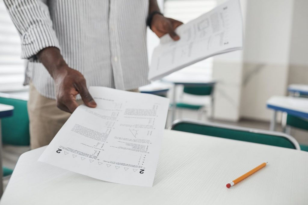 a person holding test papers
